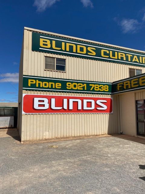 A building with a sign that says blinds on it