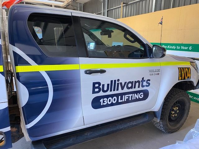A bullivants 1300 lifting truck is parked in a garage.