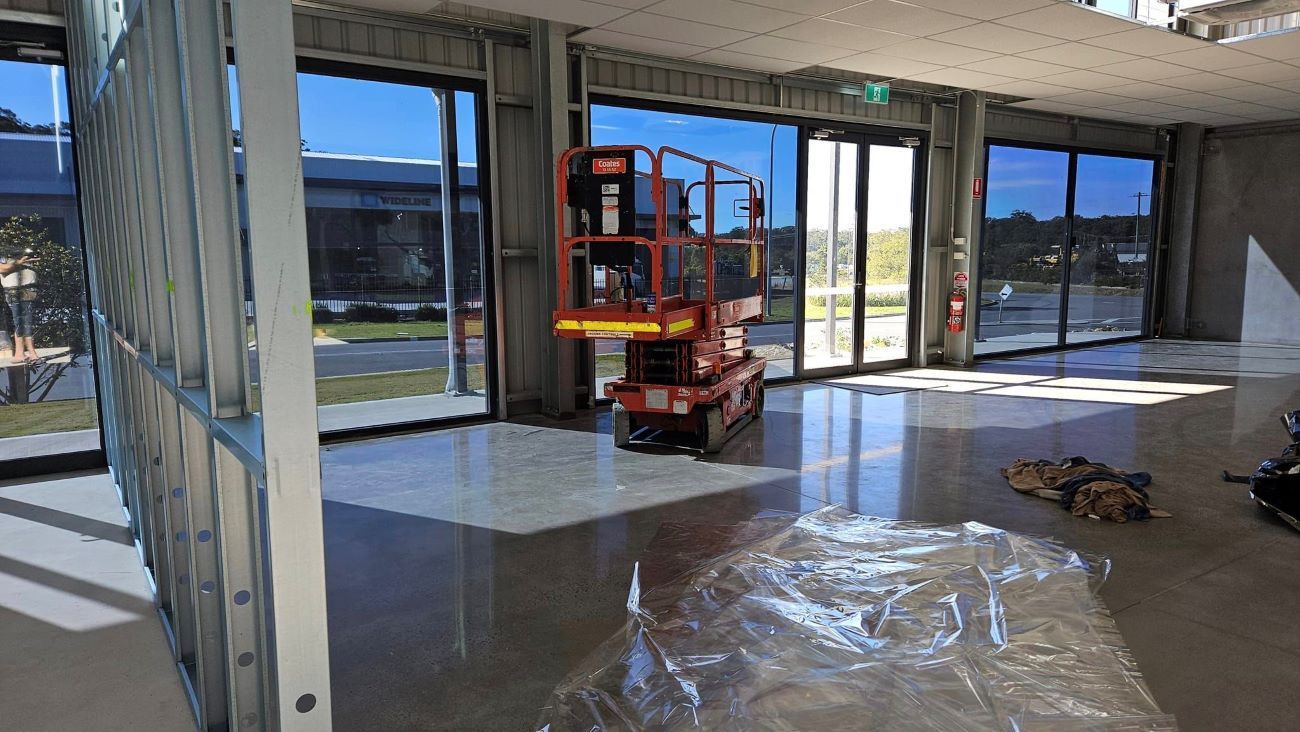 A Large Empty Room With a Tinted Windows — PJ Tinting In Laurieton, NSW