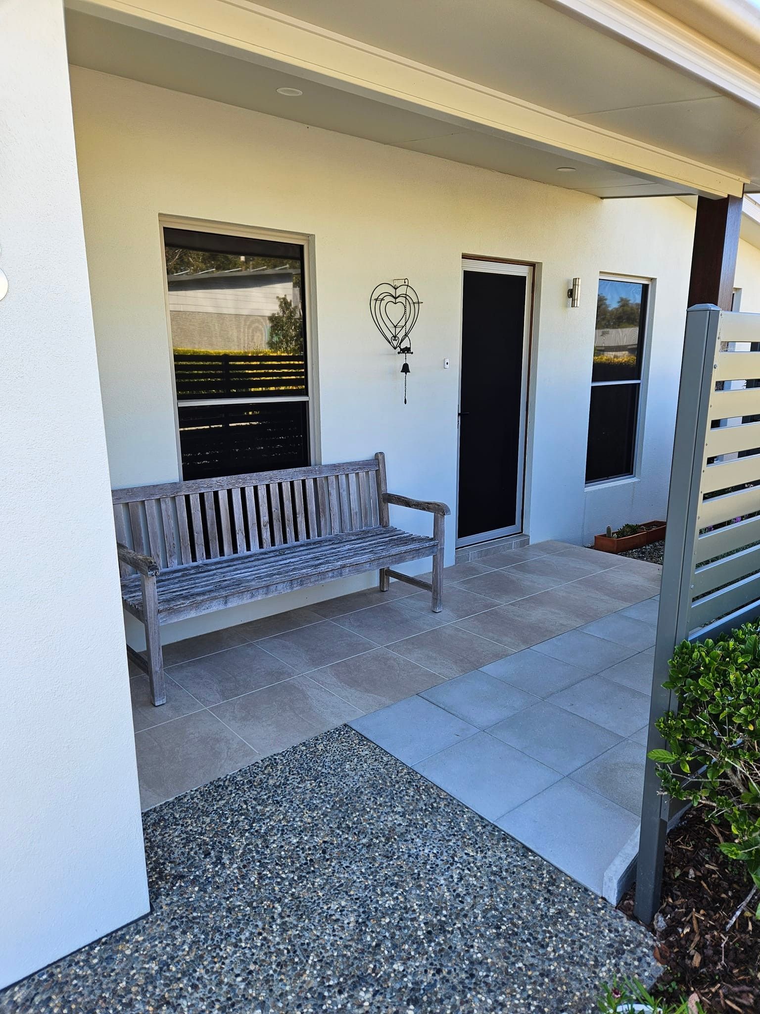 A house with tinted windows and bench chair on the porch — PJ Tinting In Port Macquarie, NSW