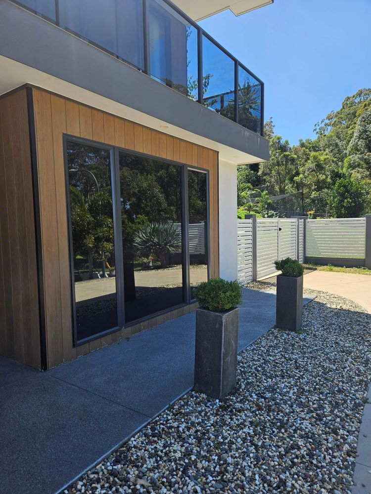 A Large House With a Balcony and a Lot of Windows — PJ Tinting In Wauchope, NSW