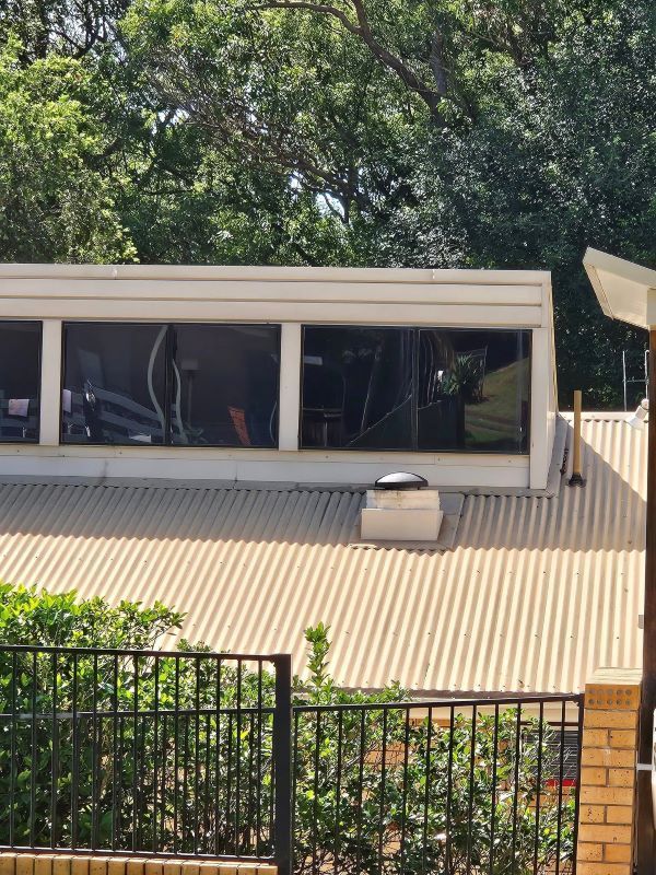A Building With a Roof That Has a Lot of Windows — PJ Tinting In Port Macquarie, NSW
