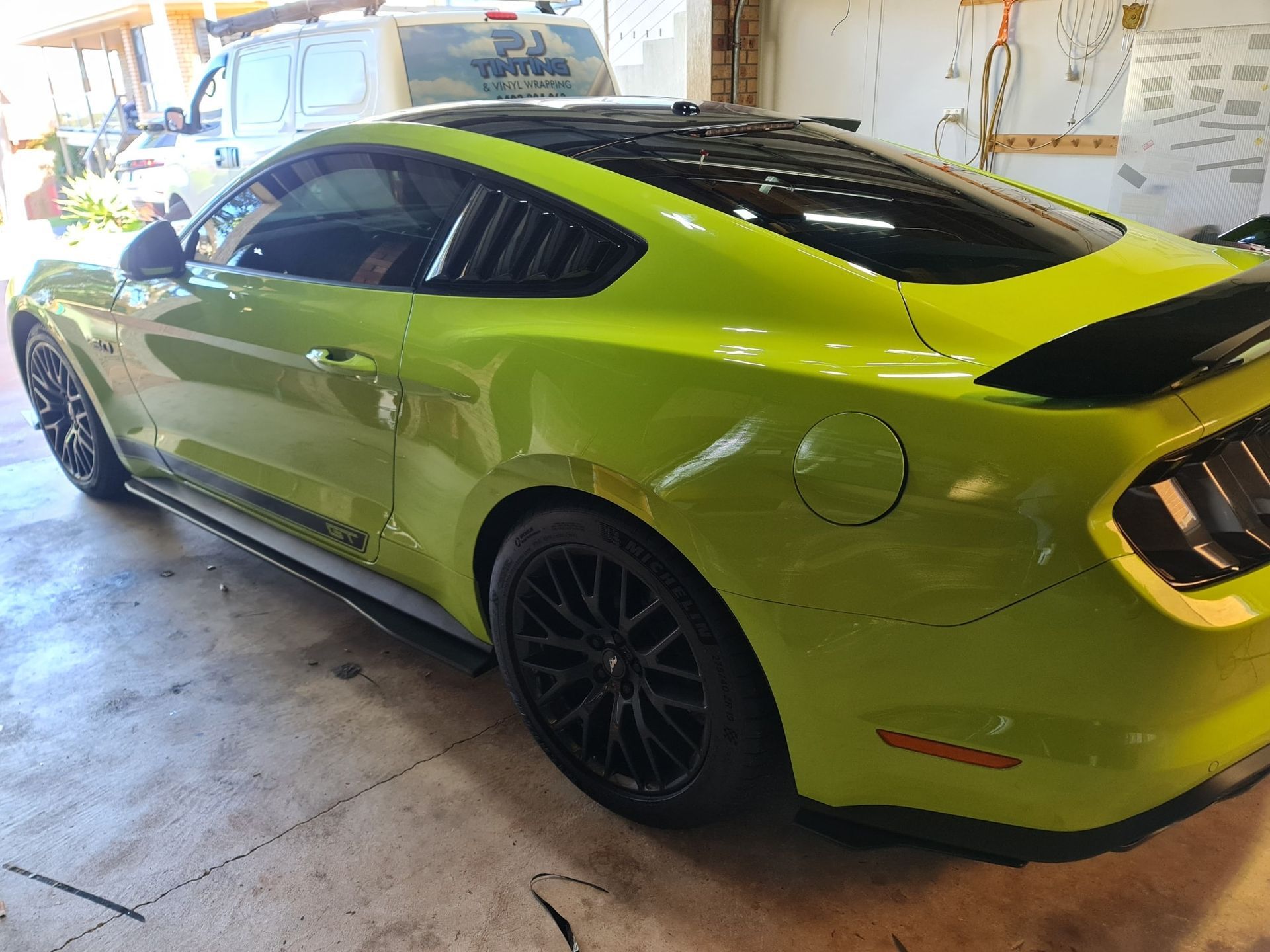 Fancy green sport car parked in a garaged with its windows tinted — PJ Tinting In Port Macquarie, NSW