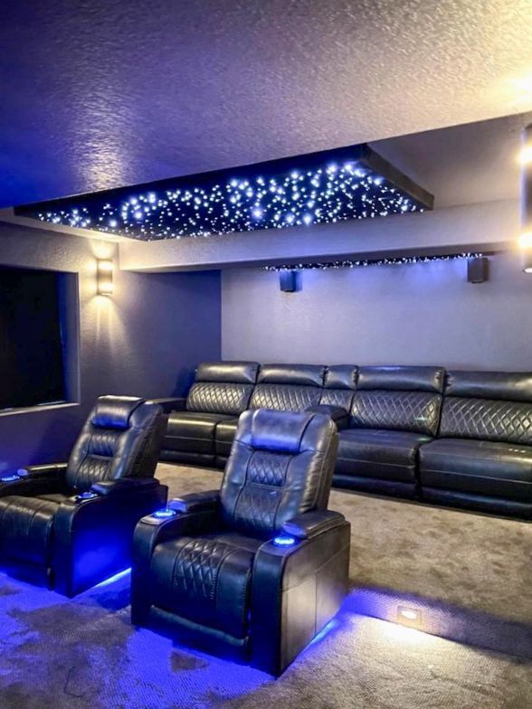 Home theater with blue LED lighting, reclining seats, and a starry ceiling panel