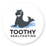 Logo of a smiling dark seal on a blue puddle with text &ldquo;TOOTHY SEALCOATING&rdquo;