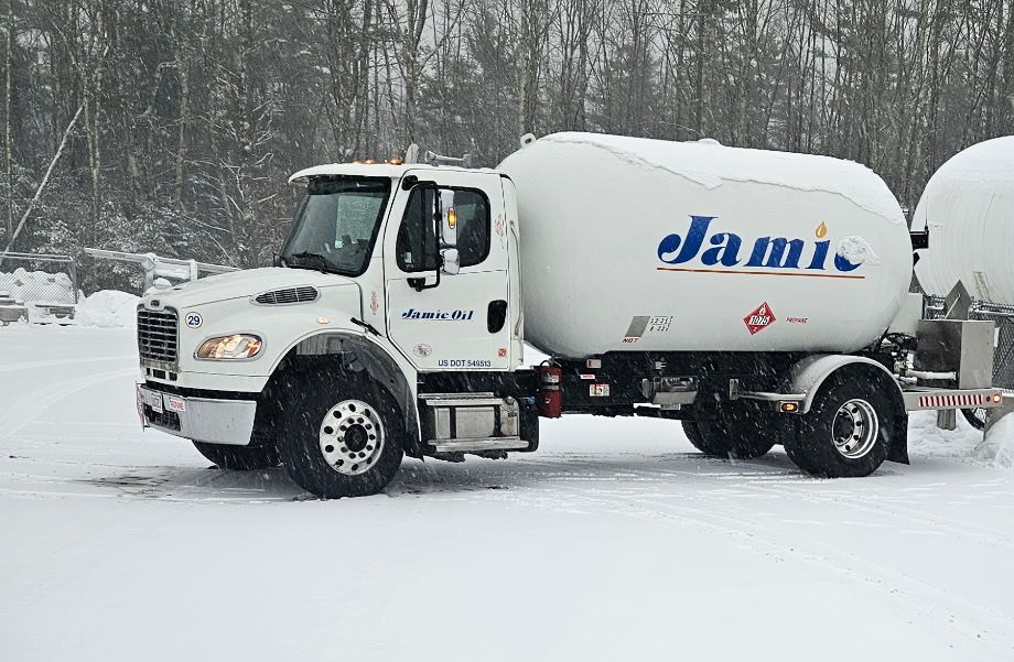 White cement mixer truck with blue logo parked in a snowy landscape White cement mixer truck with blue logo parked in a snowy landscape
