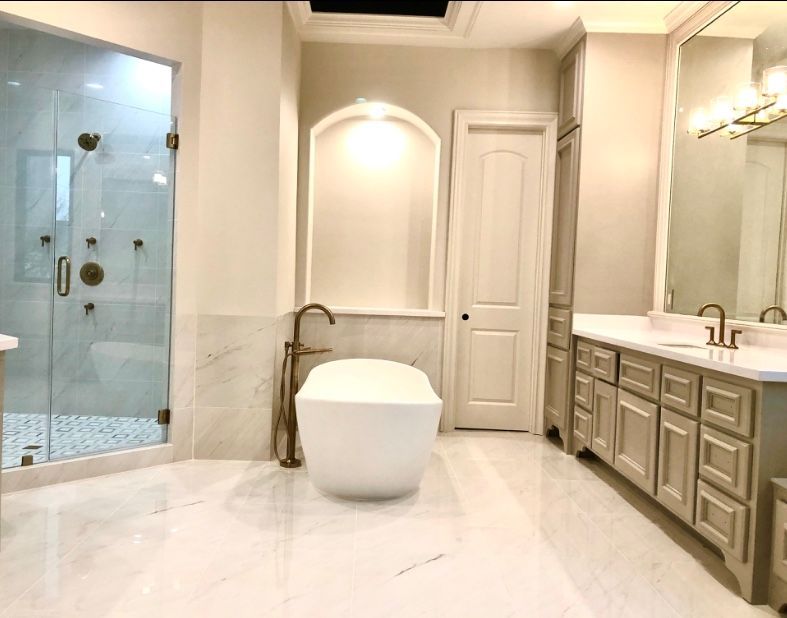 Luxurious white bathroom with glass shower, freestanding tub, and double vanity with mirrors