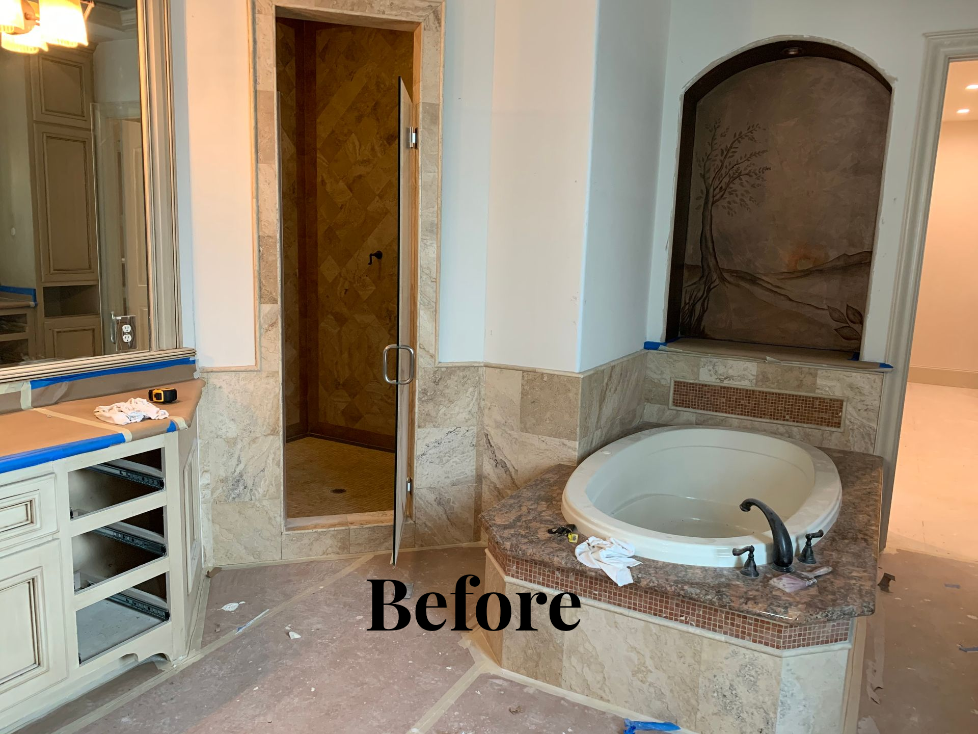 Bathroom vanity and tub area under renovation with beige tile and a “Before” label
