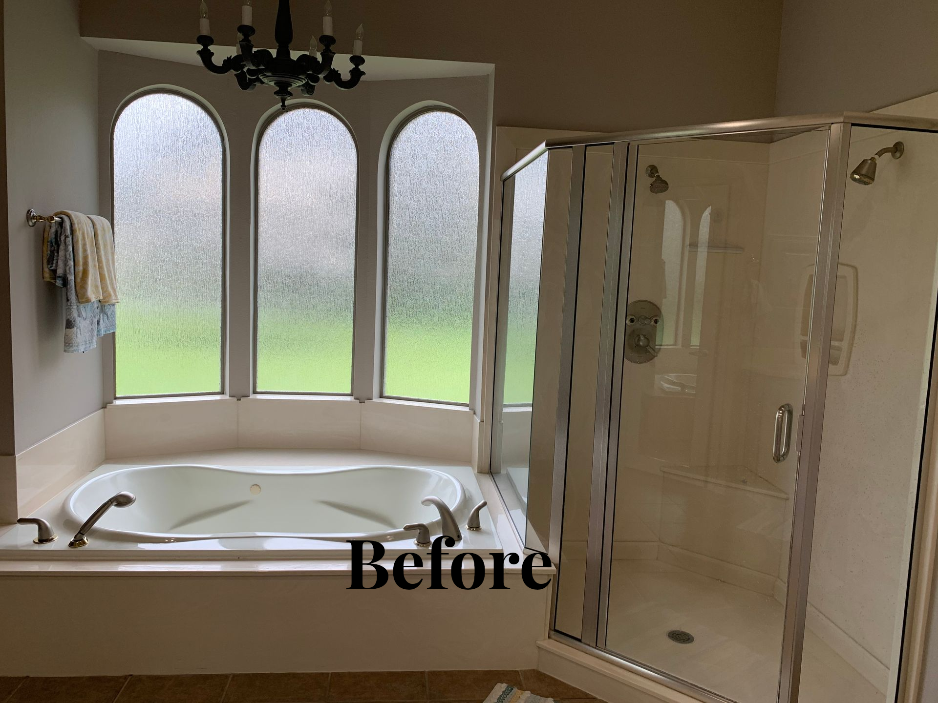 Bathroom with freestanding tub, arched windows, and glass shower enclosure; labeled “Before”