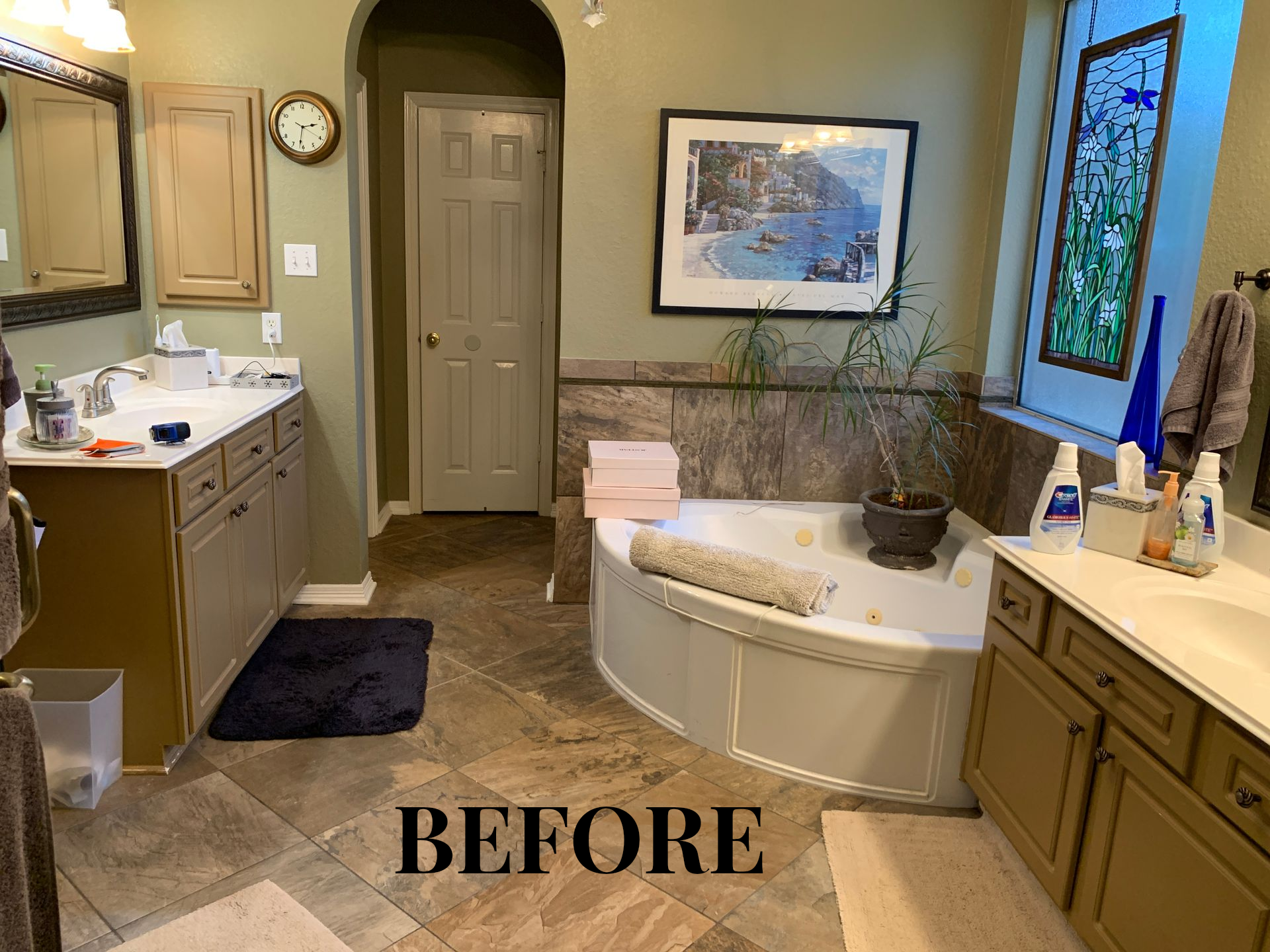 Bathroom with a curved tub, vanity, mirror, and window, labeled “BEFORE.”