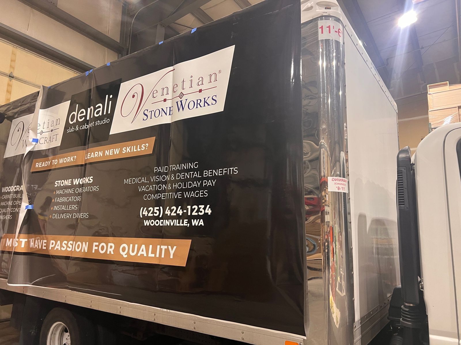 Black utility trailer with Dental Vision Works signage in an indoor warehouse.