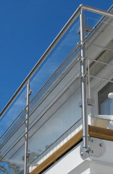 A balcony with a stainless steel railing and clear glass