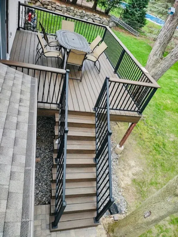 A wooden deck with a table and chairs on it