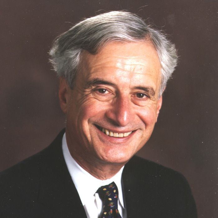 A man in a suit and tie smiles for the camera