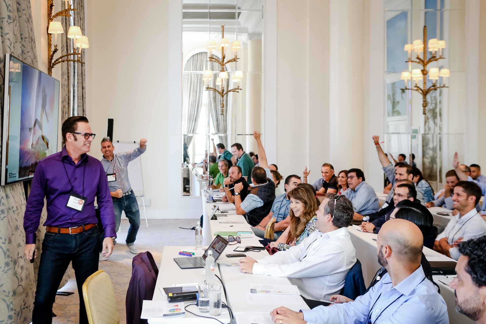 A man is giving a presentation to a group of people in a conference room.