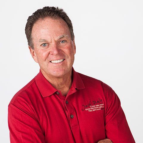 A man wearing a red polo shirt with the word colorado on it