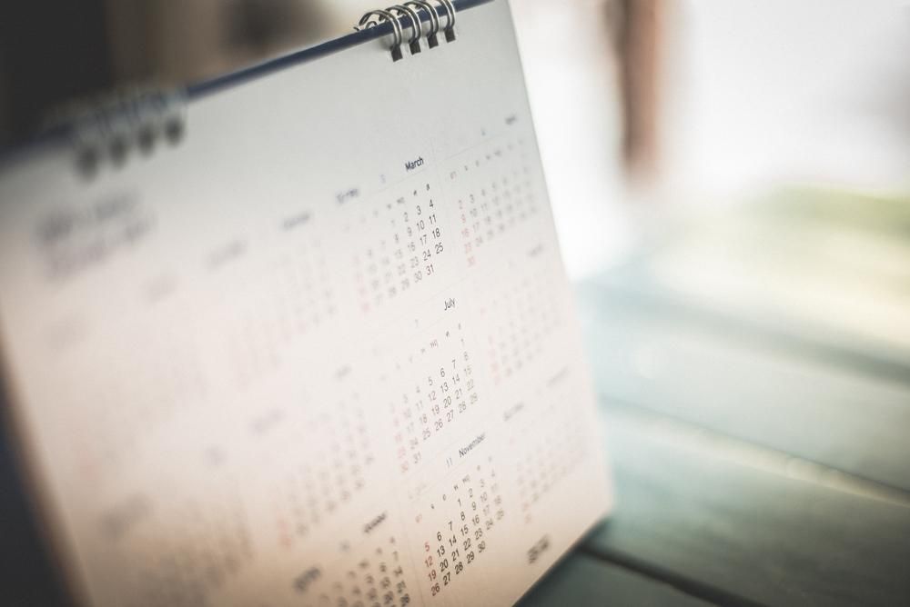 A Calendar is Sitting on a Wooden Table — Advanced Industry Training In South Townsville, QLD