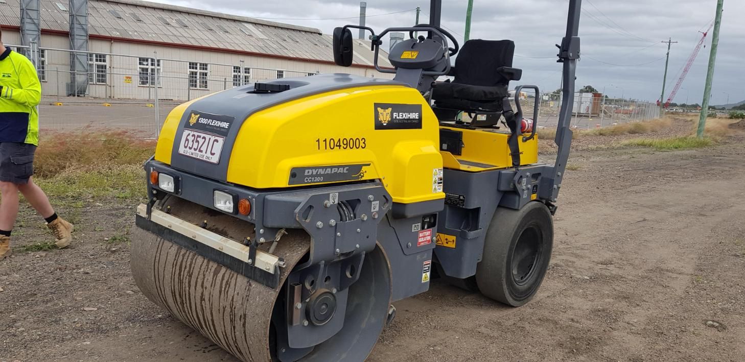 A Yellow and Gray Road Roller is Parked on a Dirt Road — Advanced Industry Training In South Townsville, QLD