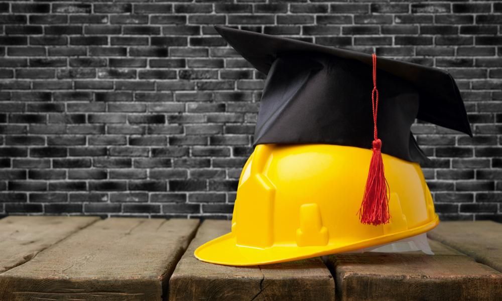 A Yellow Hard Hat With a Graduation Cap on Top of It — Advanced Industry Training In South Townsville, QLD
