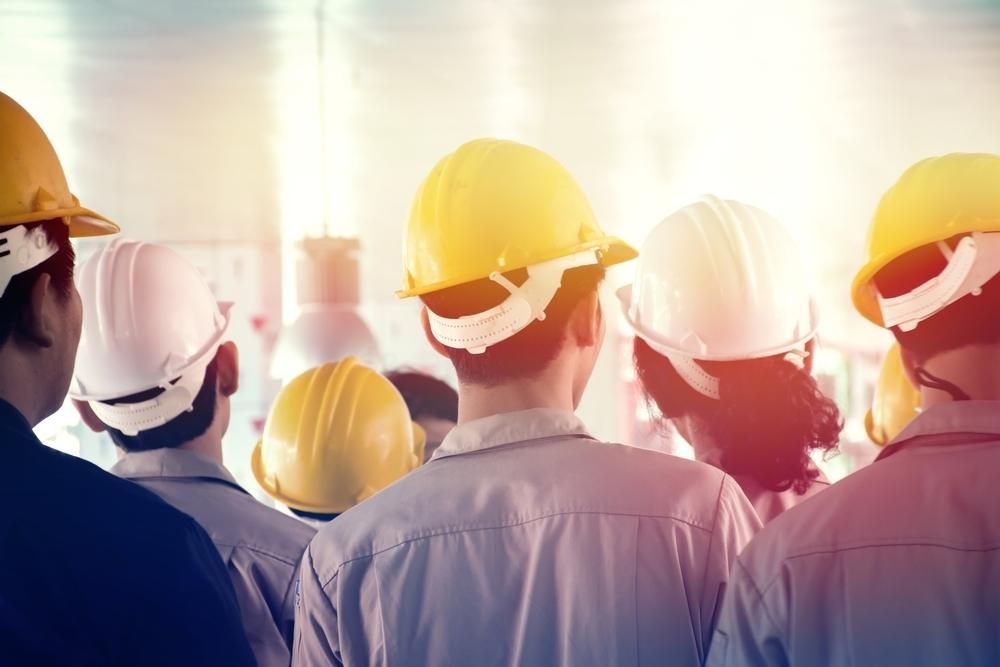 Workers Wearing Hard Hats Are Standing in a Line  — Advanced Industry Training In South Townsville, QLD