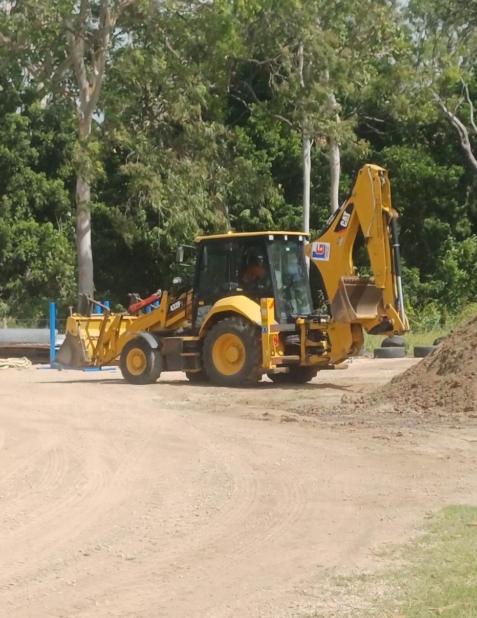 A Yellow Tractor is Parked on the Side of a Dirt Road — Advanced Industry Training In South Townsville, QLD