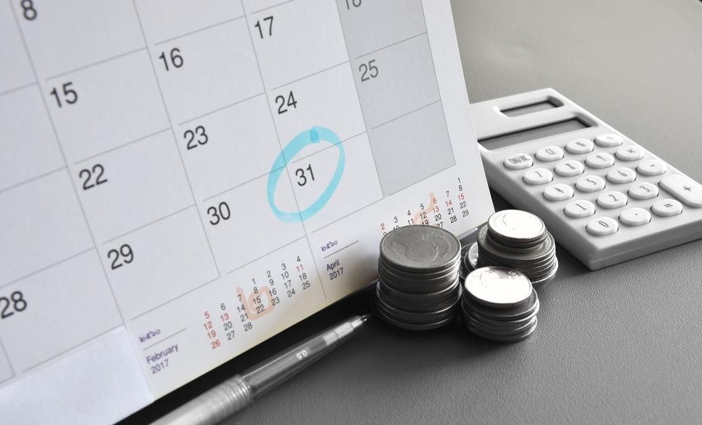 A Calendar With Coins and a Calculator on a Table — Advanced Industry Training In Mackay, QLD