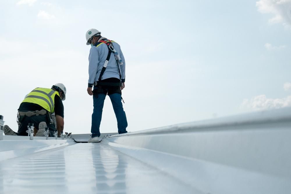 Two Construction Workers Are Working on a White Roof — Advanced Industry Training In Mackay, QLD