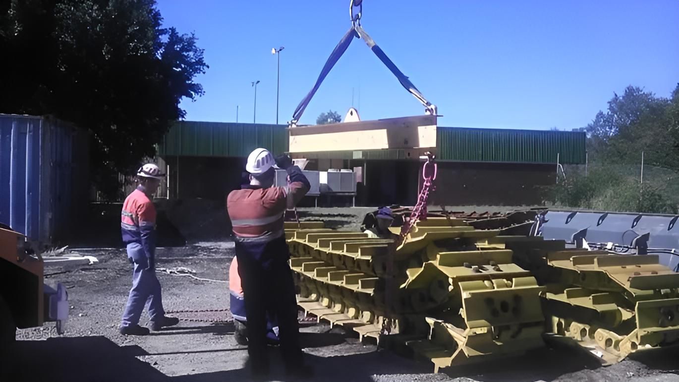 A Man is Lifting a Large Piece of Equipment That Says Cat on It — Advanced Industry Training In South Townsville, QLD