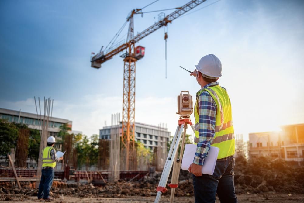Worker is Standing in Front of a Crane at a Construction Site — Advanced Industry Training In Rockhampton, QLD