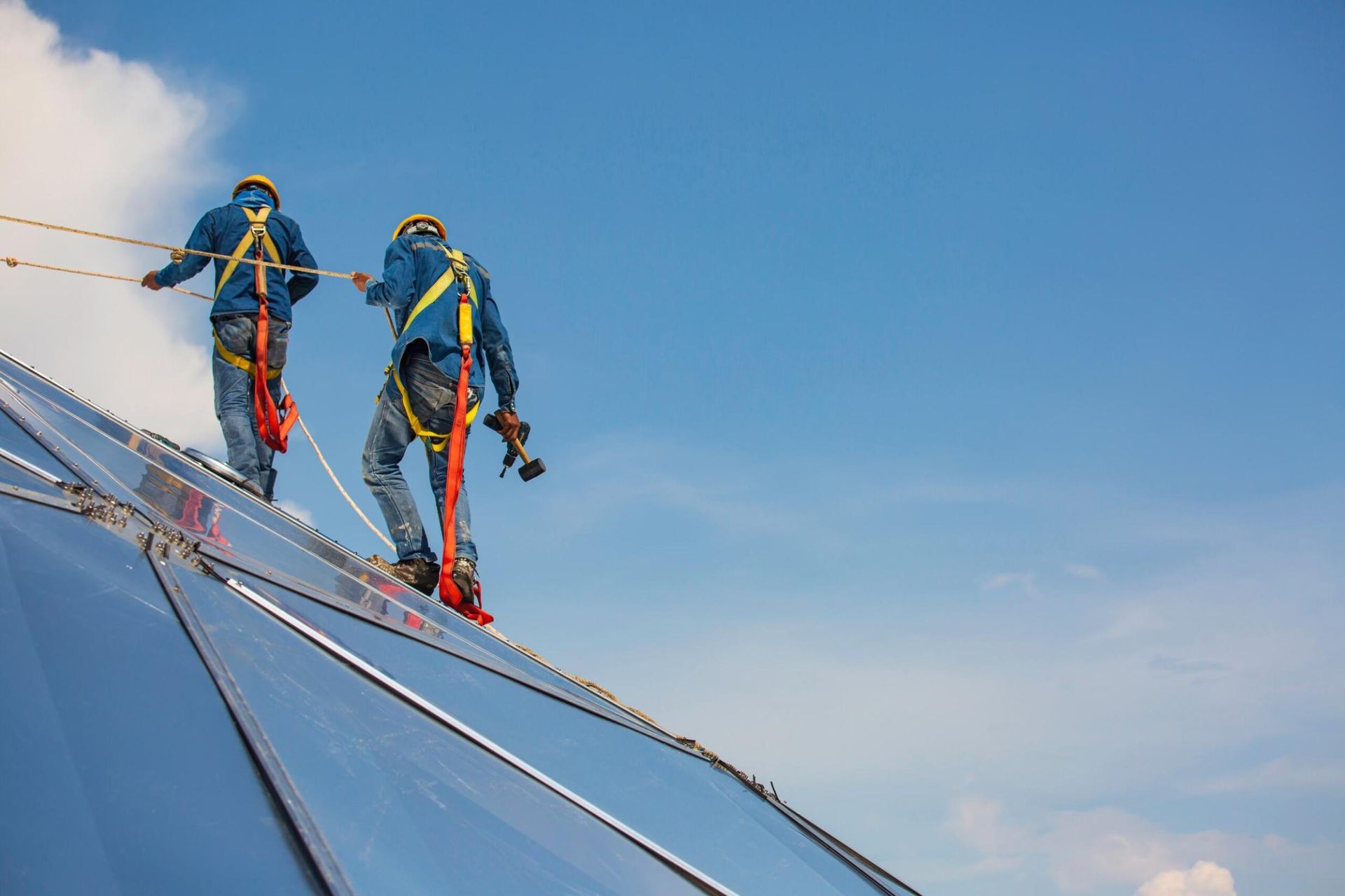 Two Men Are Working on the Roof of a Building — Advanced Industry Training In Rockhampton, QLD