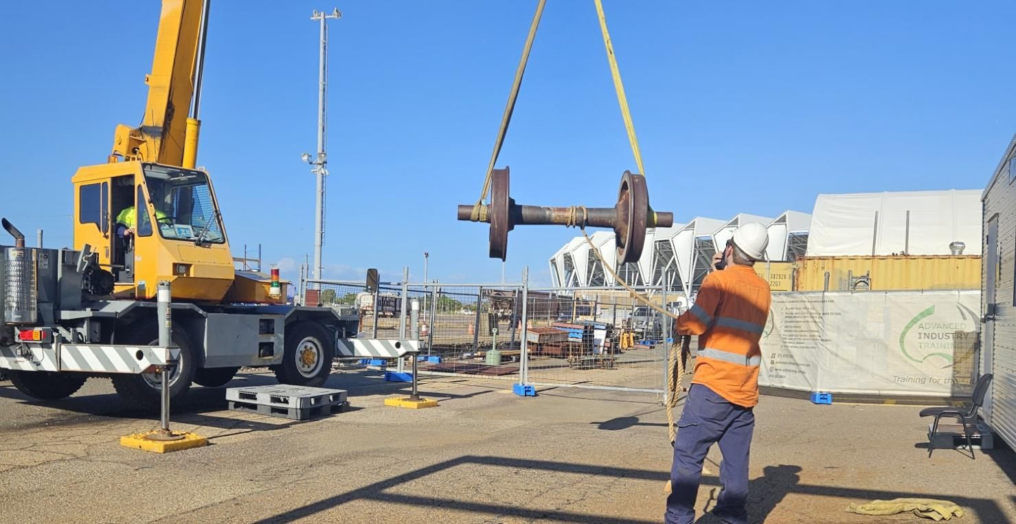 A Man is Lifting a Large Object With a Crane — Advanced Industry Training In Rockhampton, QLD