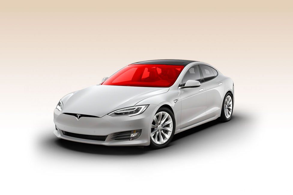 A white tesla model s with a red windshield on a white background.