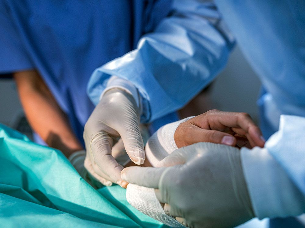 Applying Bandage On Hand — Sterling Heights, MI — Intracare Surgery Center Applying Bandage On Hand — Sterling Heights, MI — Intracare Surgery Center