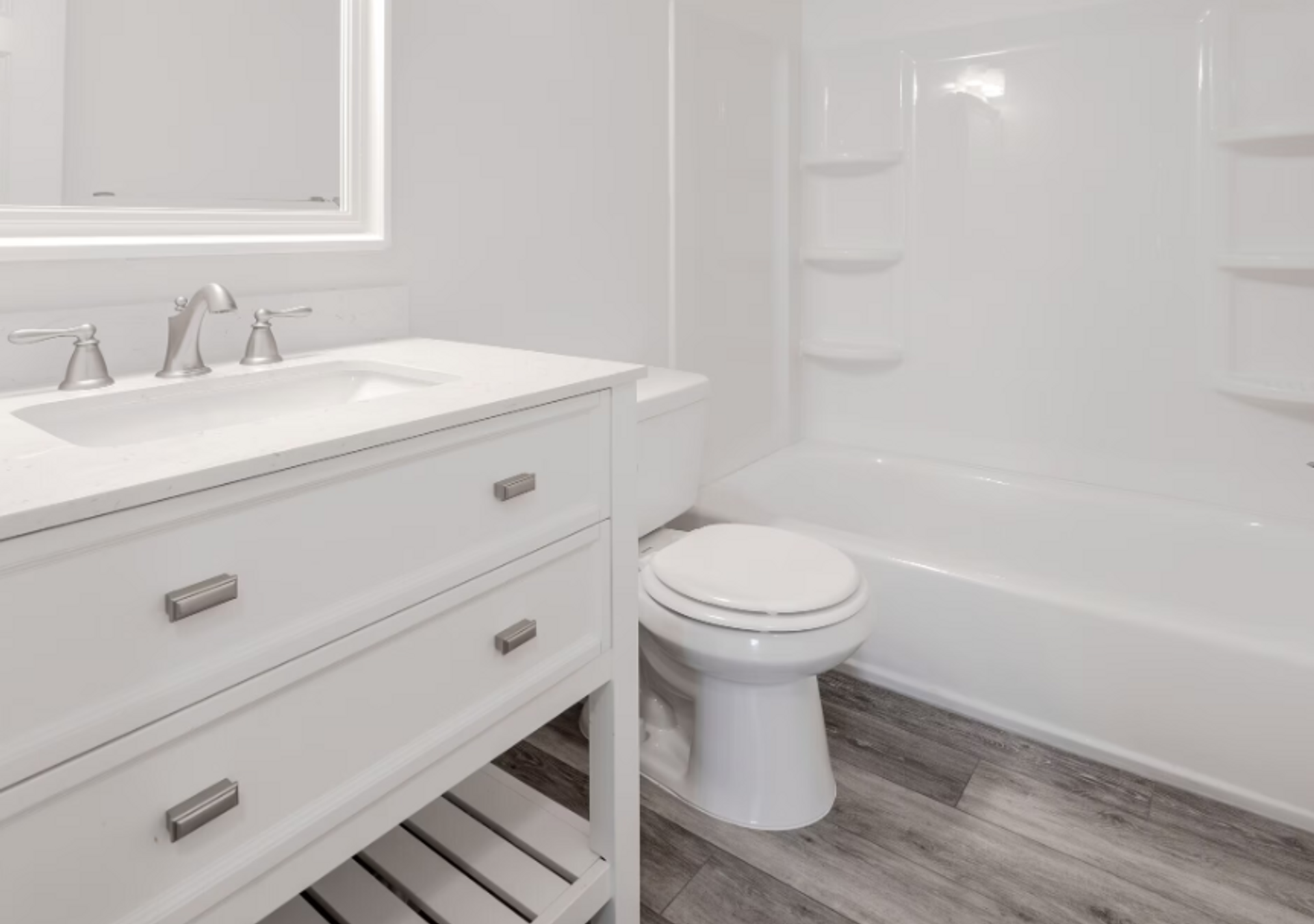 A bathroom with a toilet , sink , and bathtub.
