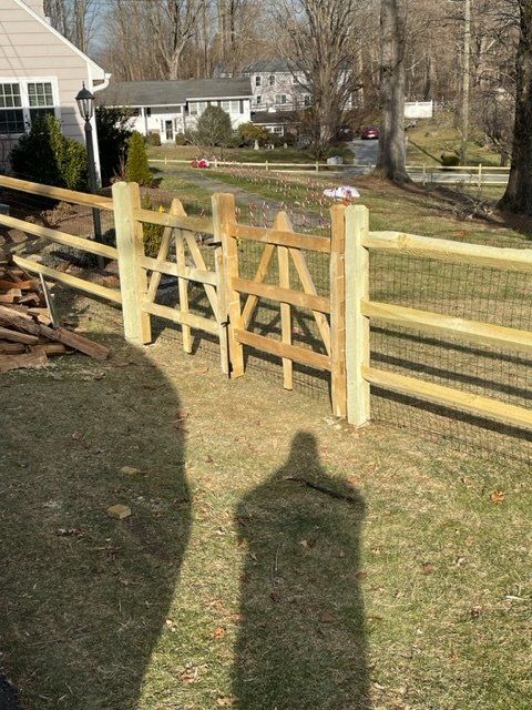 Wooden fence and gate in a suburban yard on a sunny day