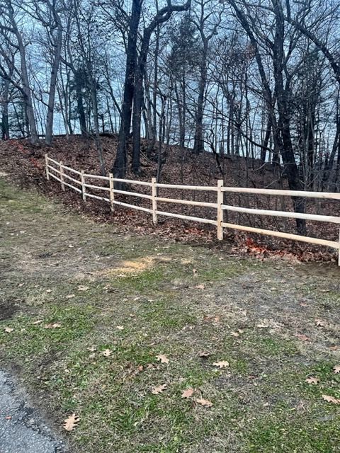 Wooden fence along a wooded hillside in late fall or winter