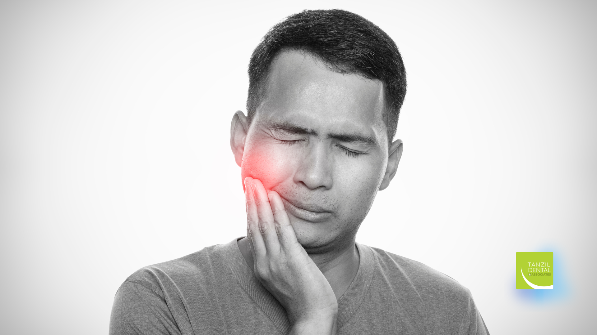 Man with painful expression, hand on jaw, red highlight indicating pain.