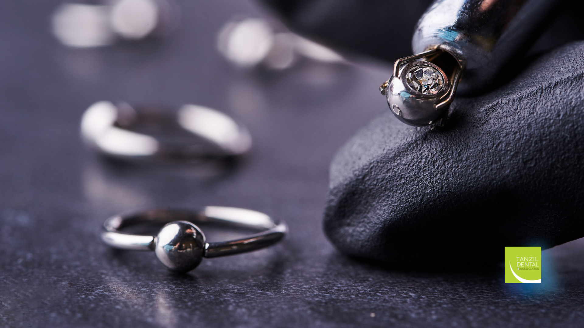 A close up of a person holding a ring on a table.
