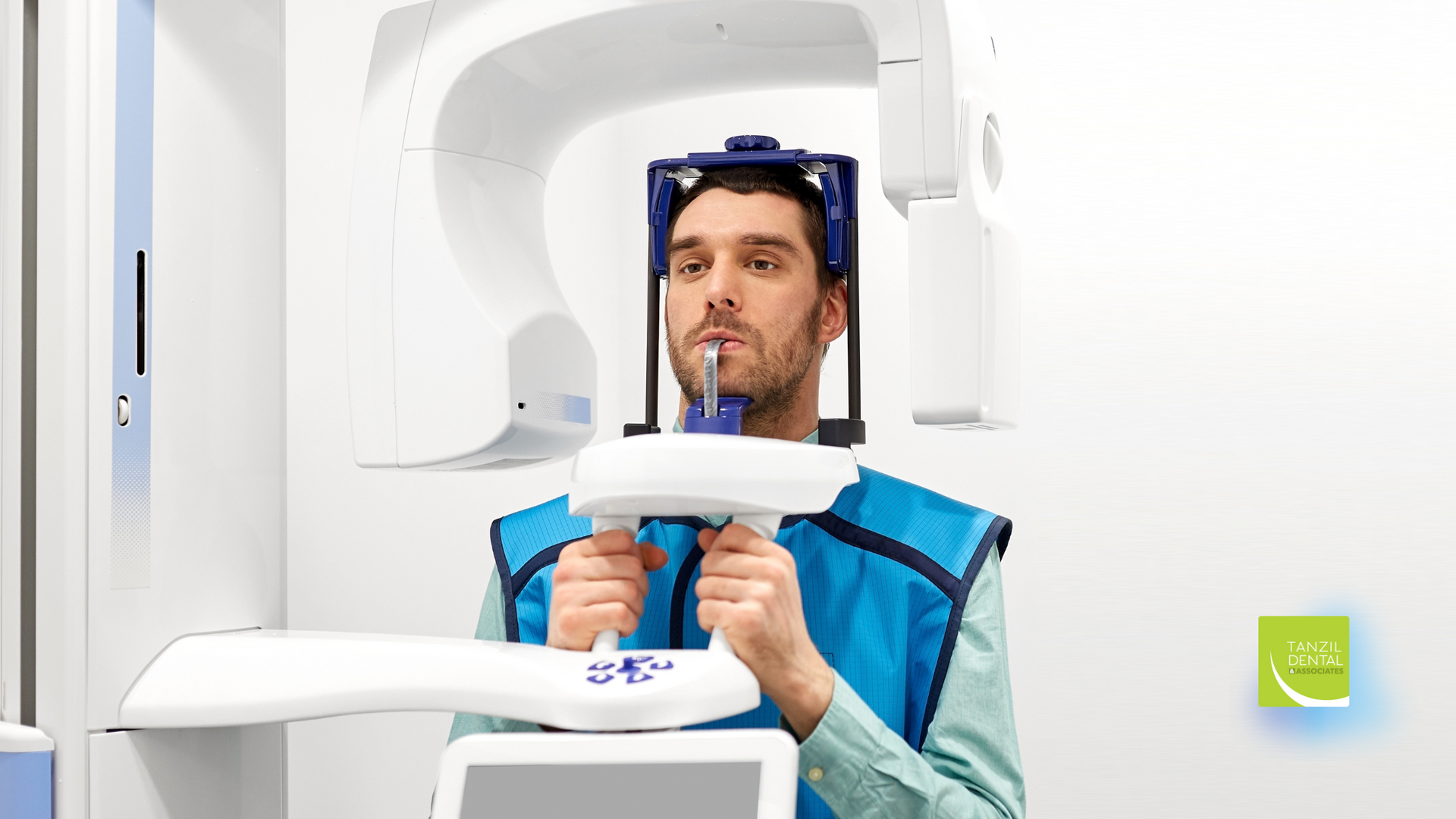 A man is getting an x-ray of his teeth in a dental office.