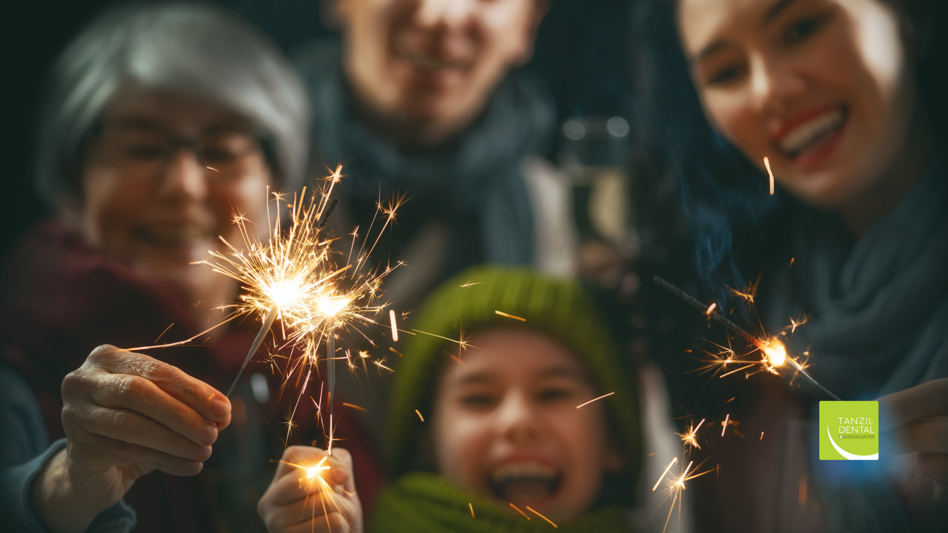 A family is holding sparklers in their hands.