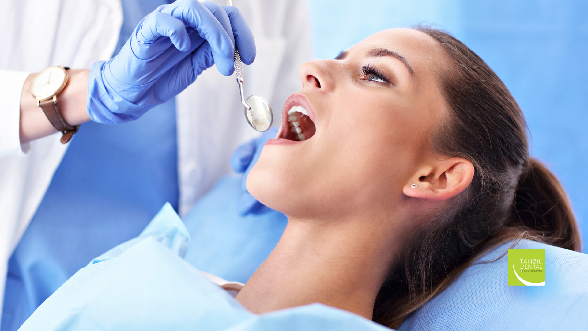 A woman is getting her teeth examined by a dentist.