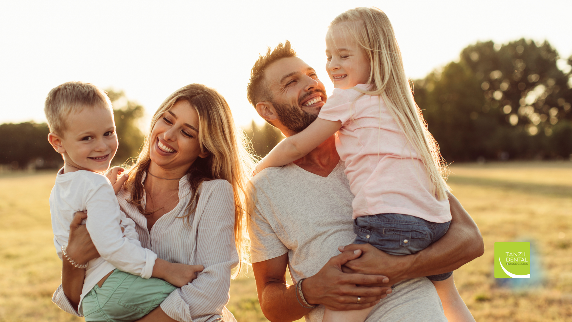 A family is posing for a picture in a field.