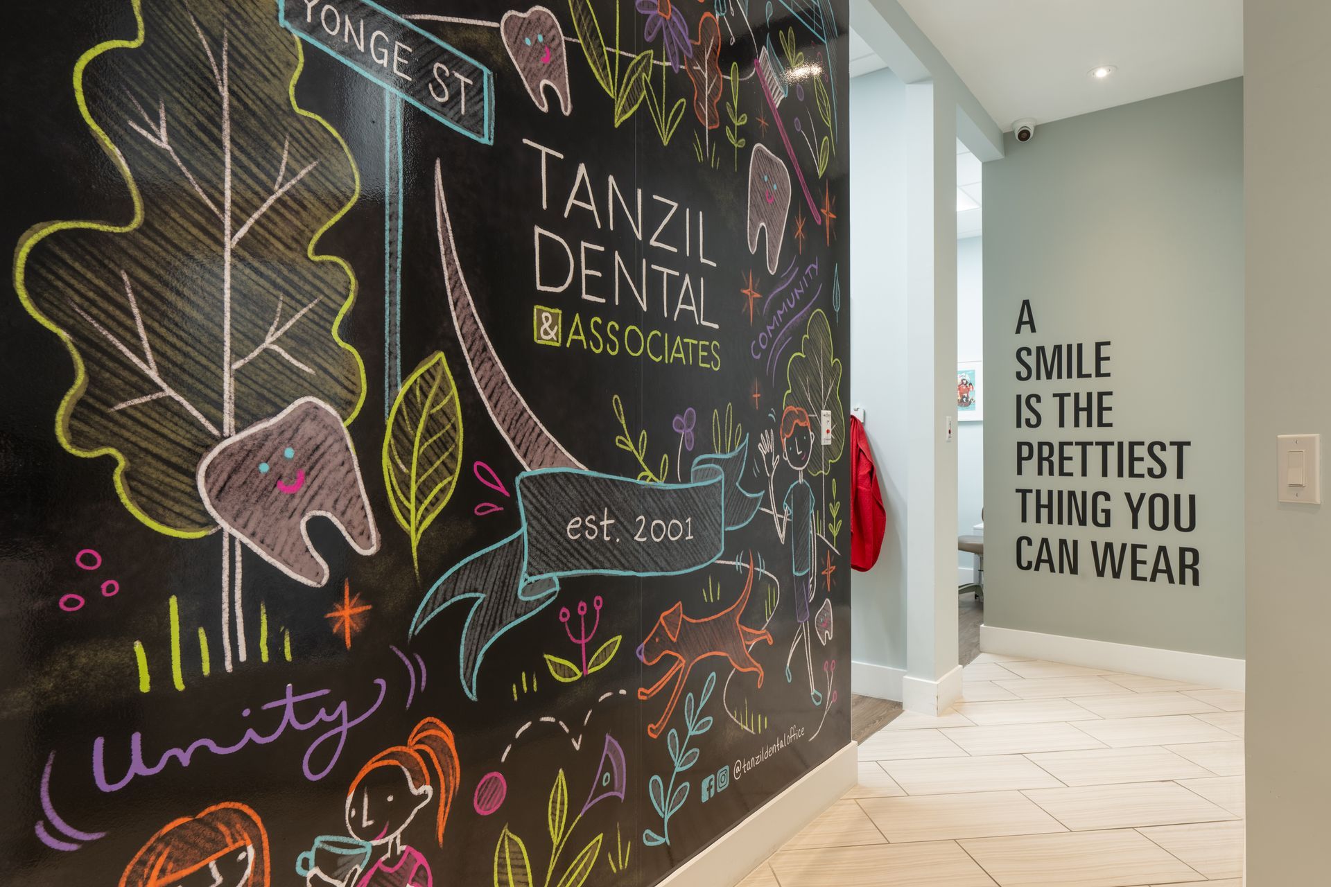 Hallway in a dental office with chalkboard art and the quote 