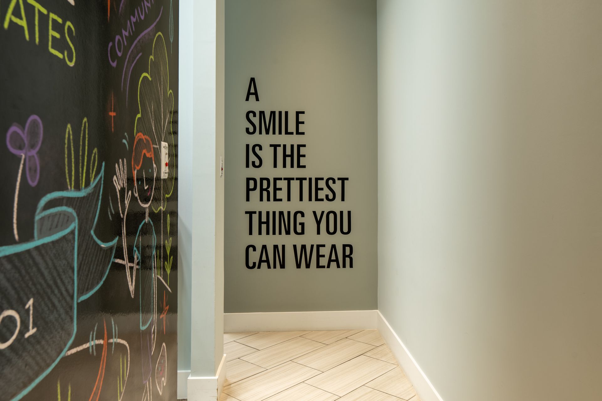 Hallway with light green walls and a quote: 