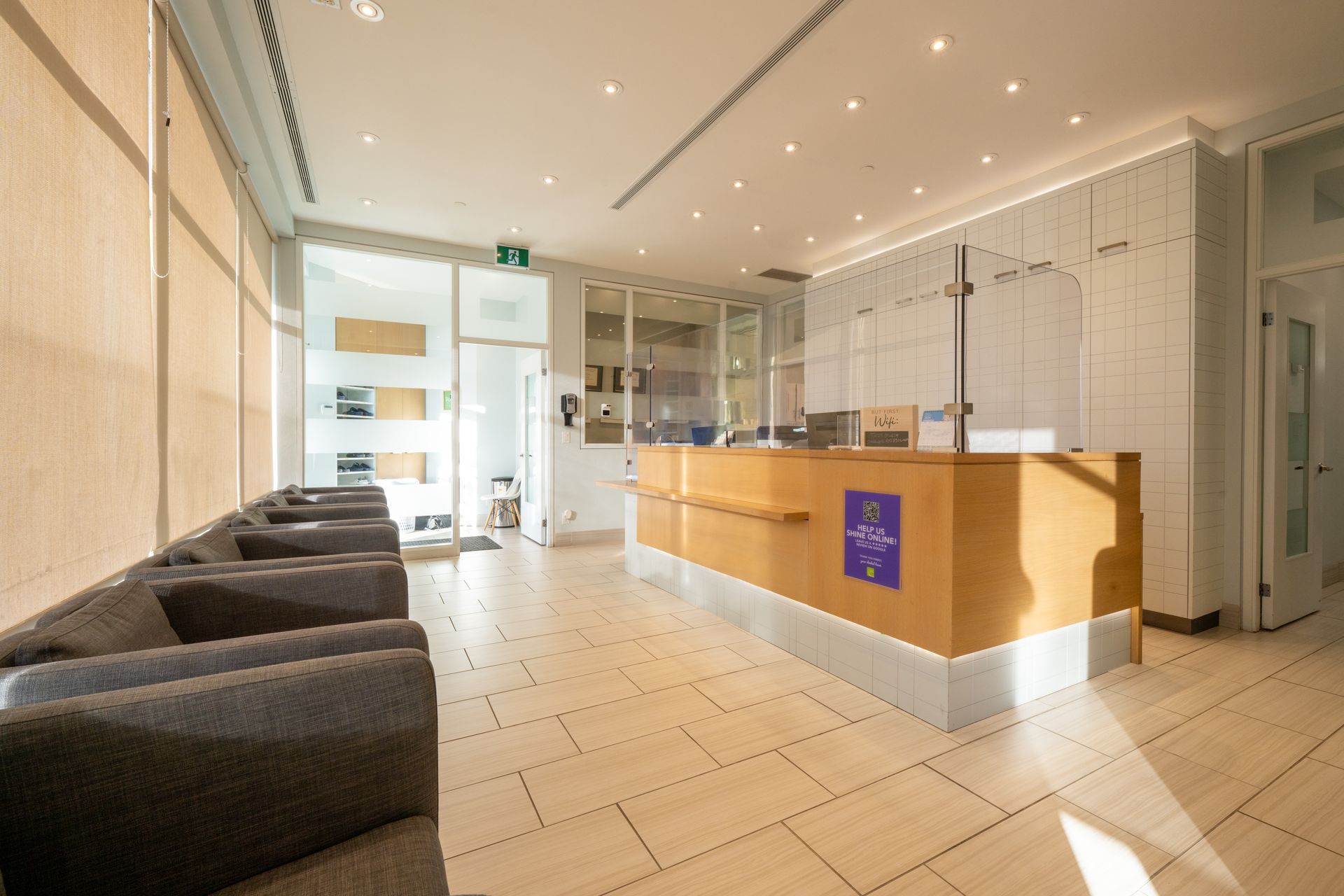 Reception area with a wooden desk and waiting chairs.