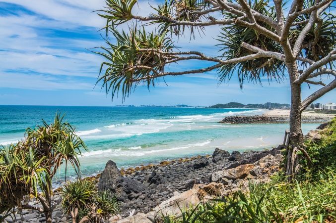 View of the Ocean From a Rocky Beach With a Tree in the Foreground — Supercare Gold Coast in Burleigh Heads, QLD