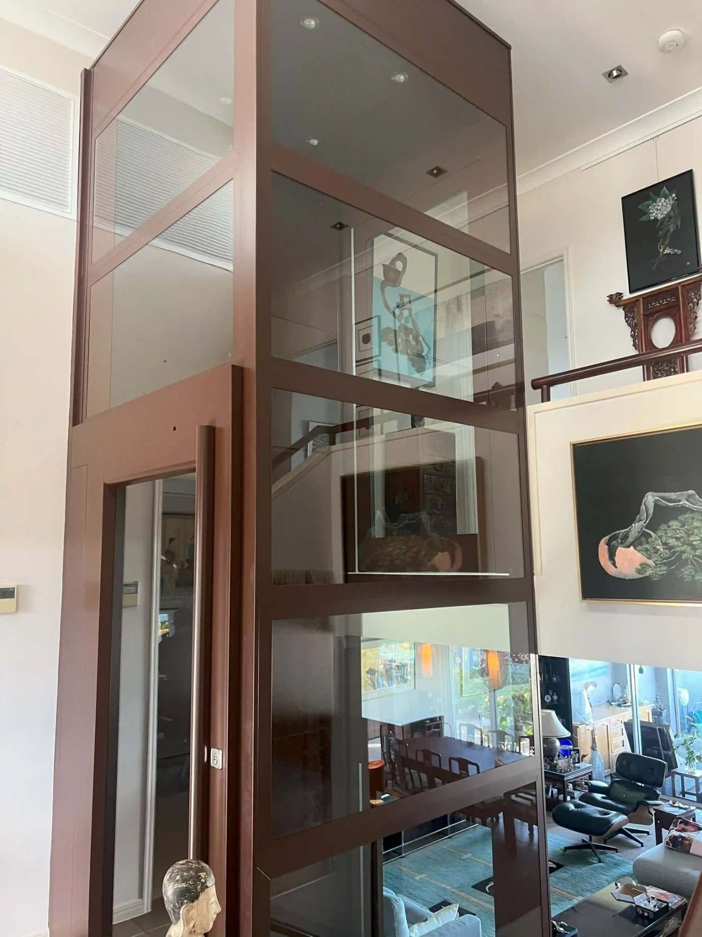 A Living Room With A Glass Elevator Going Up To The Second Floor — Supercare Gold Coast In Miami, QLD
