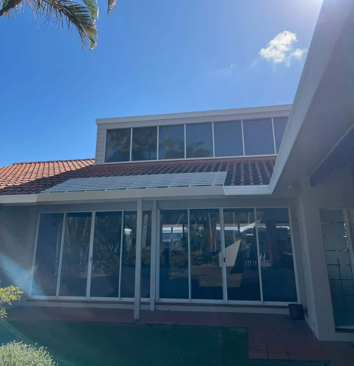 A Tiled Roof With Clean Windows And Gutters — Supercare Gold Coast in Miami, QLD