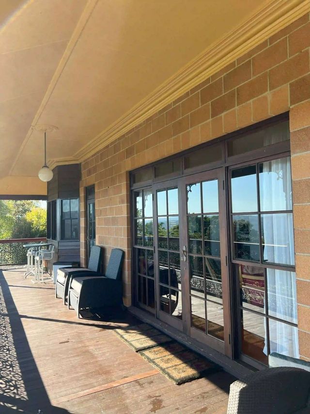 A Brick Building With A Porch And Sliding Glass Doors — Supercare Gold Coast in Miami, QLD