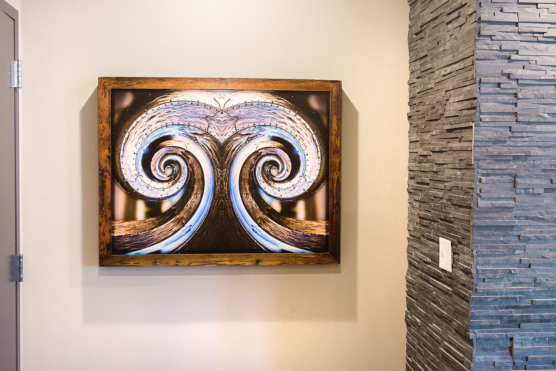 Artwork in a brown frame on a beige wall